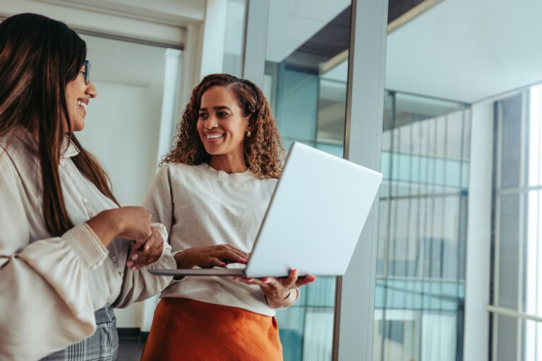 Two women talking about the upcoming National Accounting Day on May 19th