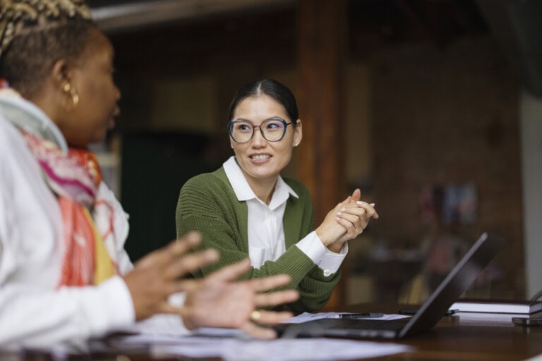 two women discussing Ai in finance for midmarket companies