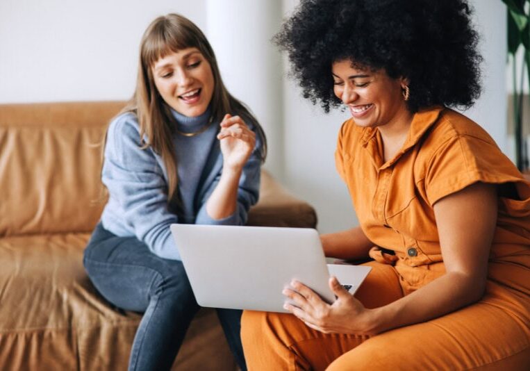 Two women discussing PEX's crawl, walk, run approach for adopting Ai in finance