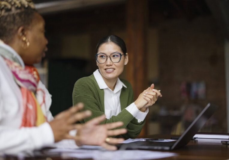 two women discussing Ai in finance for midmarket companies