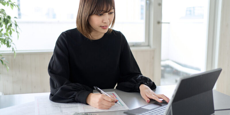 Asian woman preparing tax return documents
