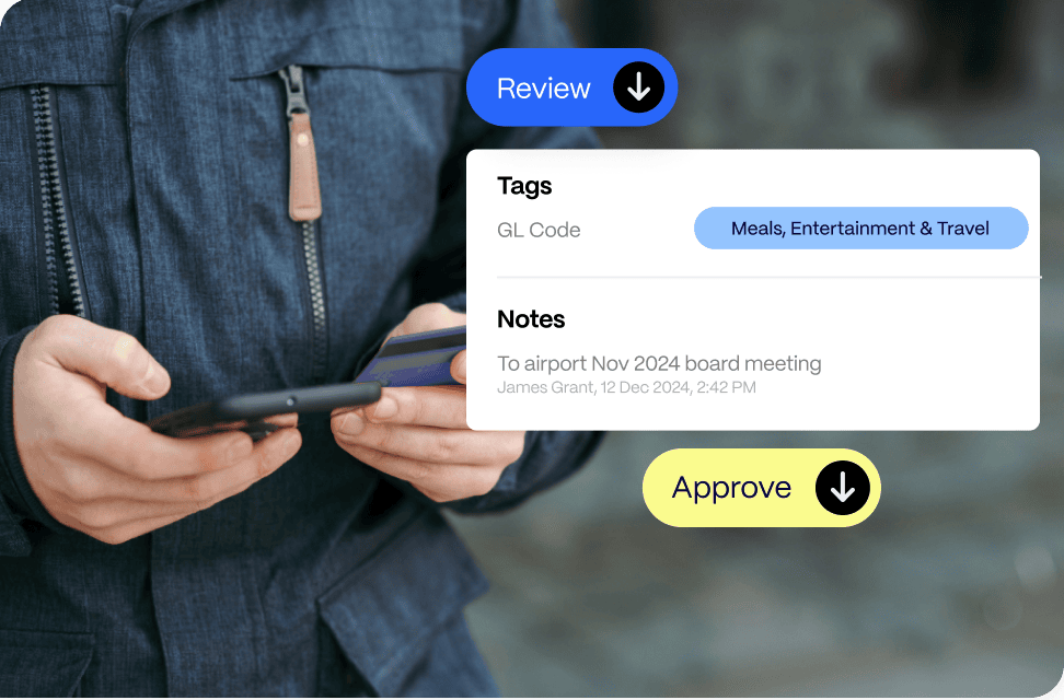 customize-company-workflows Person holding a smartphone, interacting with a financial app showing options for review, tags for expenses, notes, and an approval button.