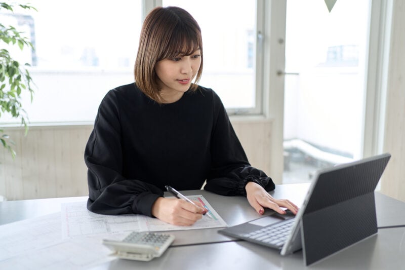 Asian woman preparing tax return documents